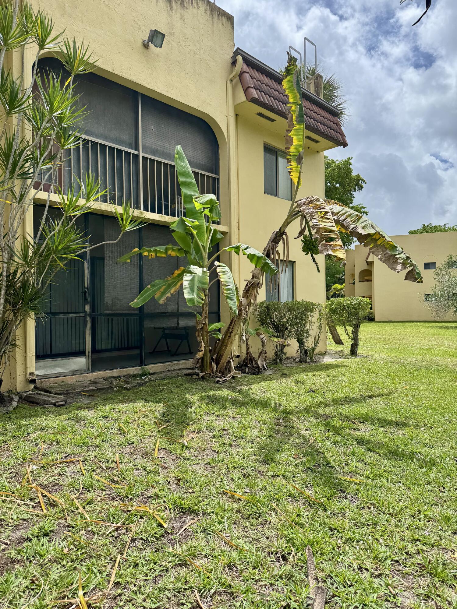 912 Southwest 9th St Circle, Unit 101 Boca Raton, FL 33486 - Photo 21 of 25 a view of a house with a backyard