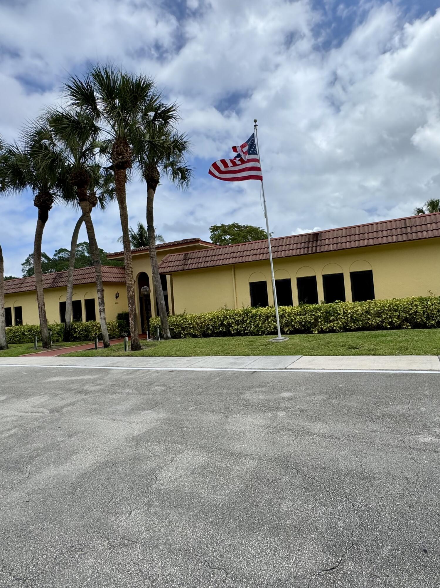 912 Southwest 9th St Circle, Unit 101 Boca Raton, FL 33486 - Photo 22 of 25 a front view of a house with a yard and garage
