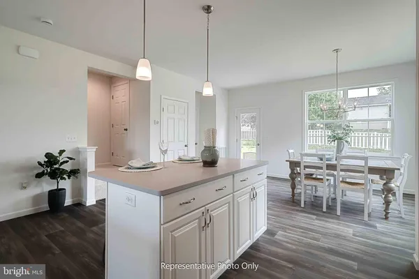 a kitchen with center island table and chairs in it