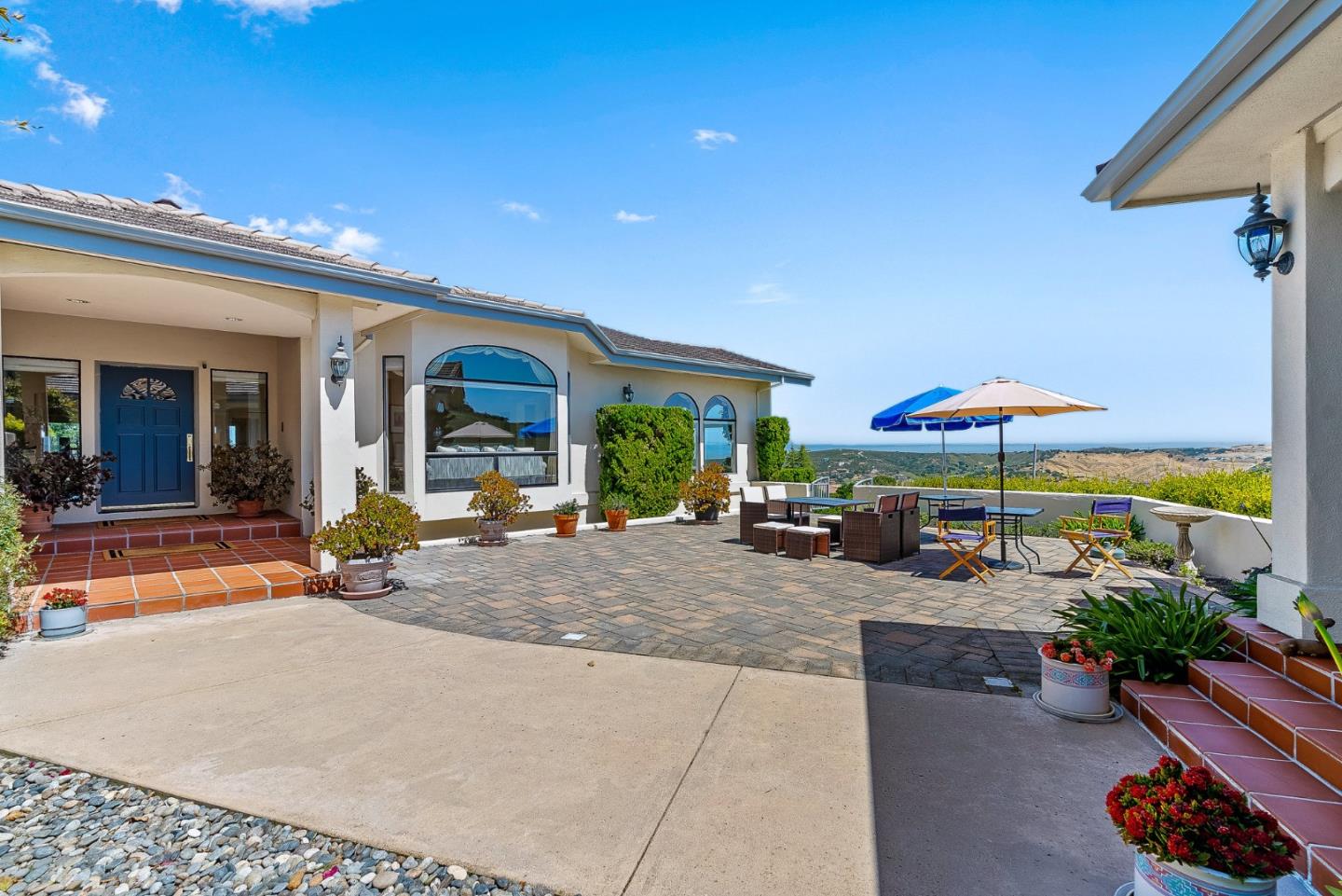 25611 Whip Road Monterey, CA 93940 - Photo 3 of 29 a view of a patio with a table and chairs under an umbrella