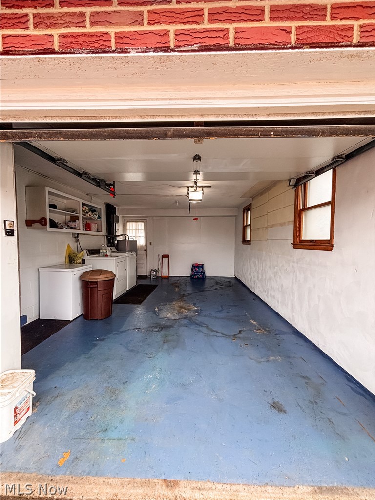 724 East Main Street Barnesville, OH 43713 - Photo 22 of 28 Garage featuring white fridge and washer and clothes dryer