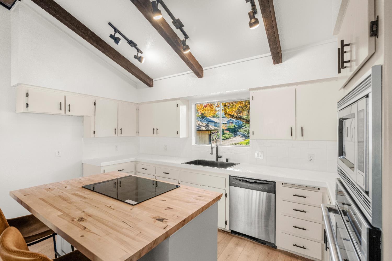 24626 Oro Valley Road Auburn, CA 95602 - Photo 12 of 54 a kitchen that has a sink and a stove in it