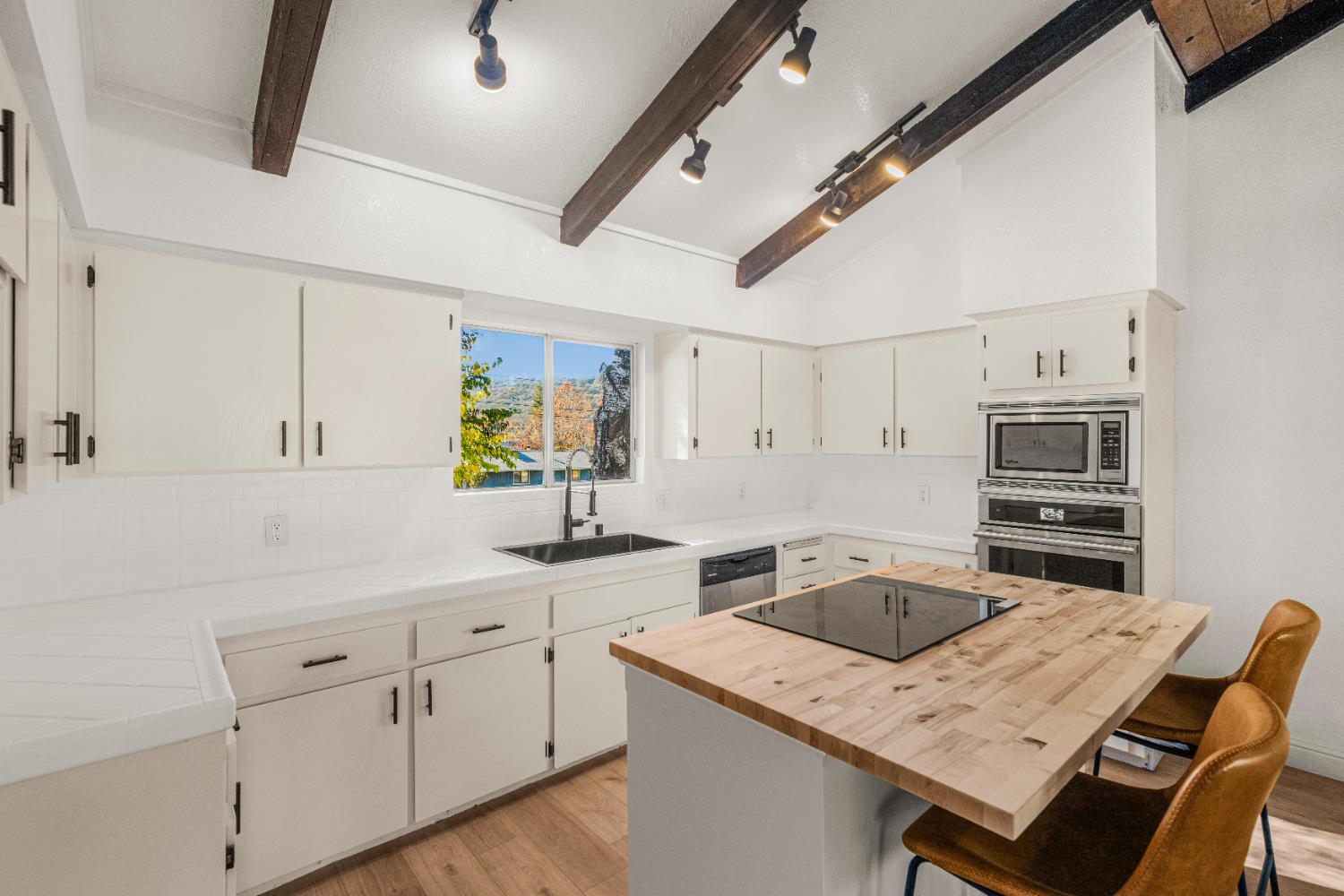 24626 Oro Valley Road Auburn, CA 95602 - Photo 13 of 54 a kitchen with a stove sink and cabinets