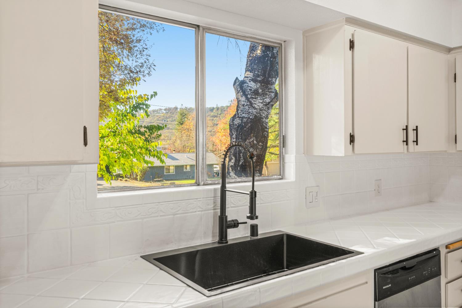 24626 Oro Valley Road Auburn, CA 95602 - Photo 15 of 54 a bathroom with a sink a mirror and a shower