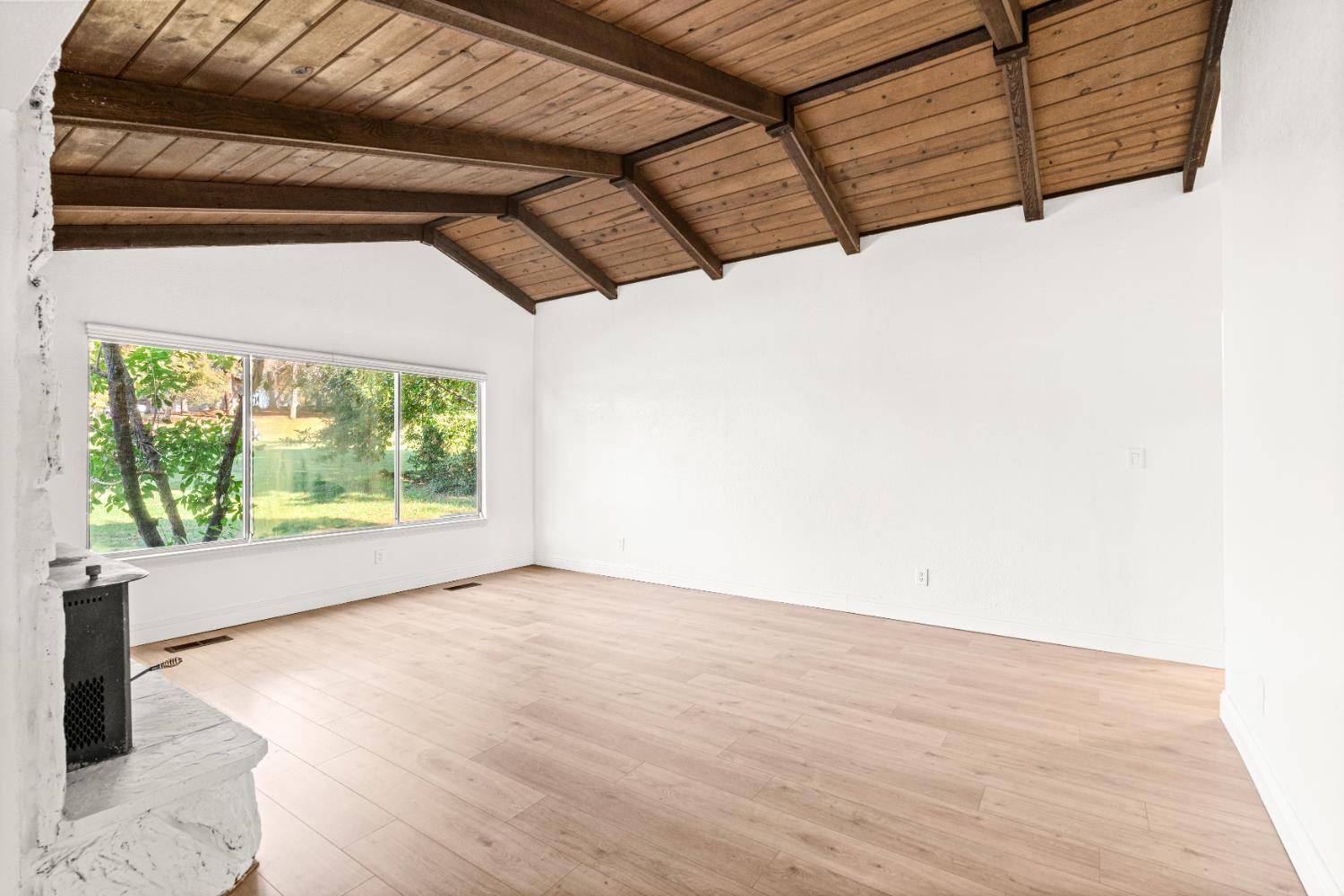 24626 Oro Valley Road Auburn, CA 95602 - Photo 23 of 54 a view of a room with wooden floor and a window