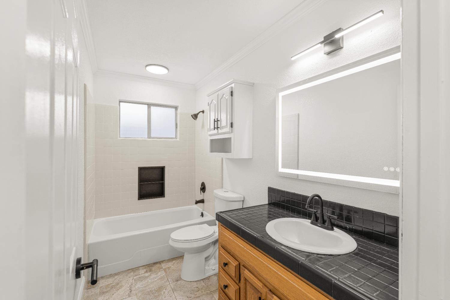 24626 Oro Valley Road Auburn, CA 95602 - Photo 26 of 54 a bathroom with a granite countertop sink toilet a mirror and shower