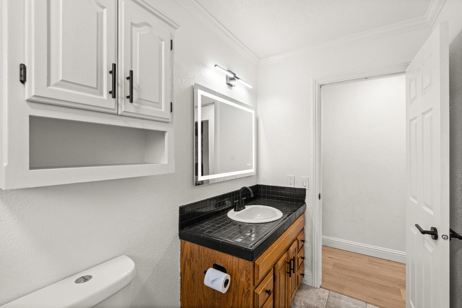 24626 Oro Valley Road Auburn, CA 95602 - Photo 27 of 54 a bathroom with a sink vanity granite and a mirror