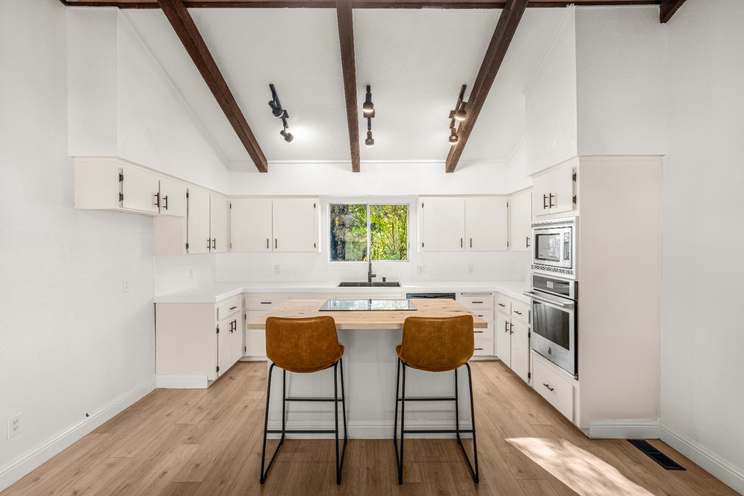 24626 Oro Valley Road Auburn, CA 95602 - Photo 10 of 54 a kitchen with stainless steel appliances a table and chairs