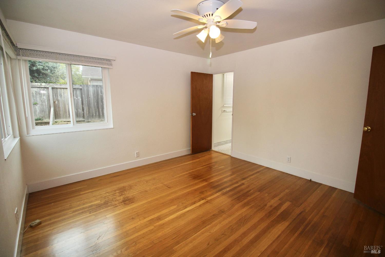599 Tamarack Drive San Rafael, CA 94903 - Photo 13 of 20 a view of an empty room with wooden floor and a window