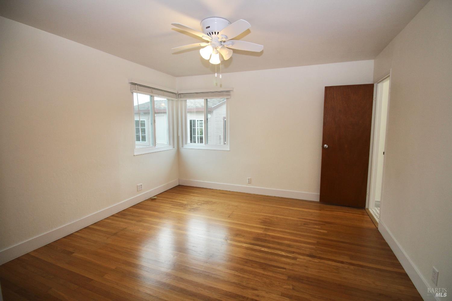 599 Tamarack Drive San Rafael, CA 94903 - Photo 14 of 20 an empty room with wooden floor and windows