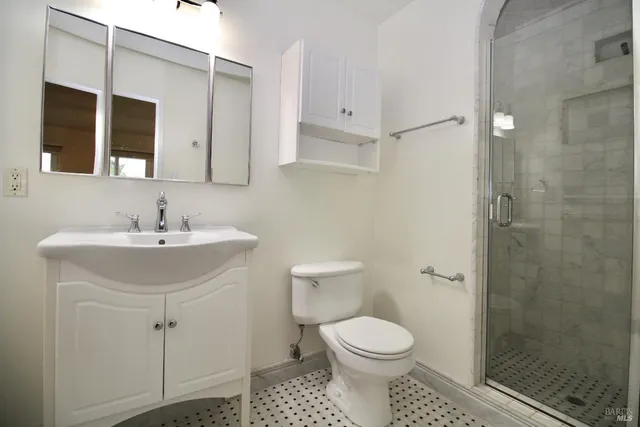 a bathroom with a sink toilet and shower