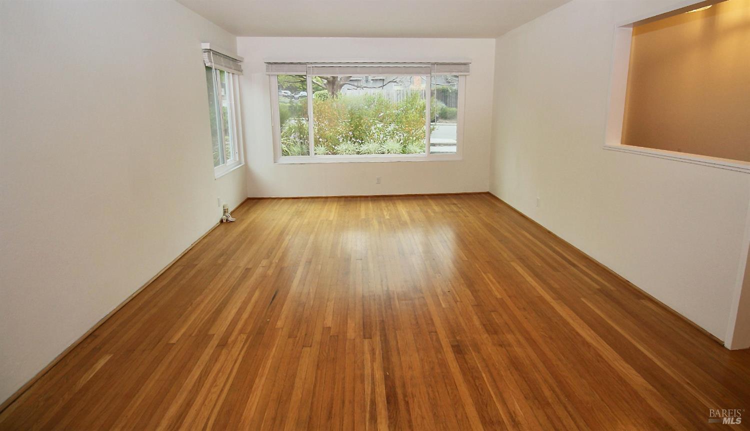 599 Tamarack Drive San Rafael, CA 94903 - Photo 2 of 20 an empty room with wooden floor and windows