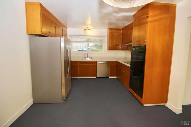 a kitchen with cabinets and stainless steel appliances