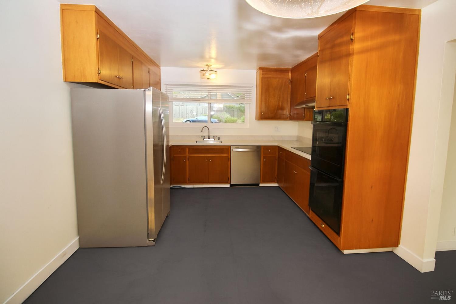 599 Tamarack Drive San Rafael, CA 94903 - Photo 3 of 20 a kitchen with cabinets and stainless steel appliances