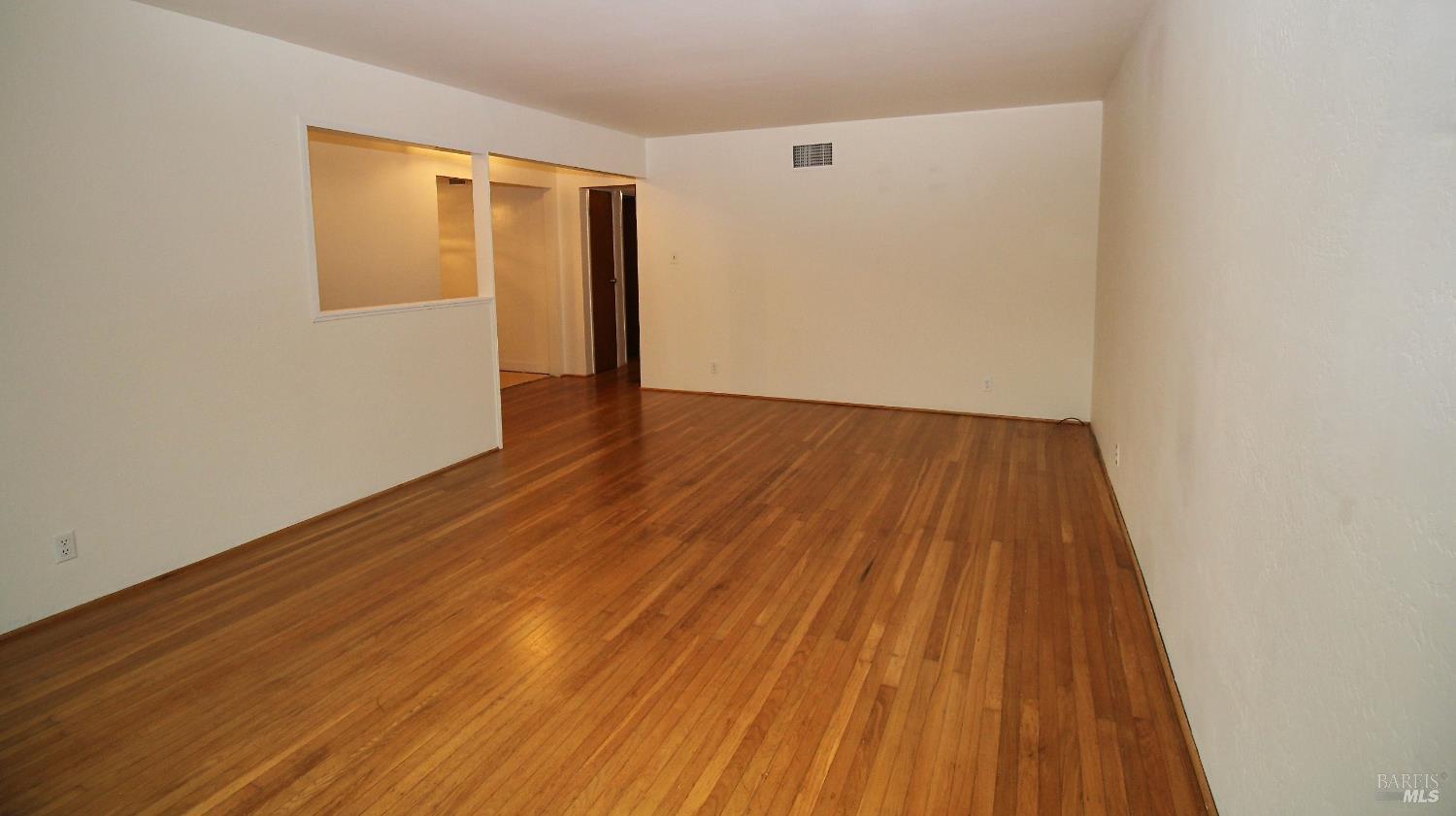 599 Tamarack Drive San Rafael, CA 94903 - Photo 4 of 20 a view of an empty room with wooden floor and a window
