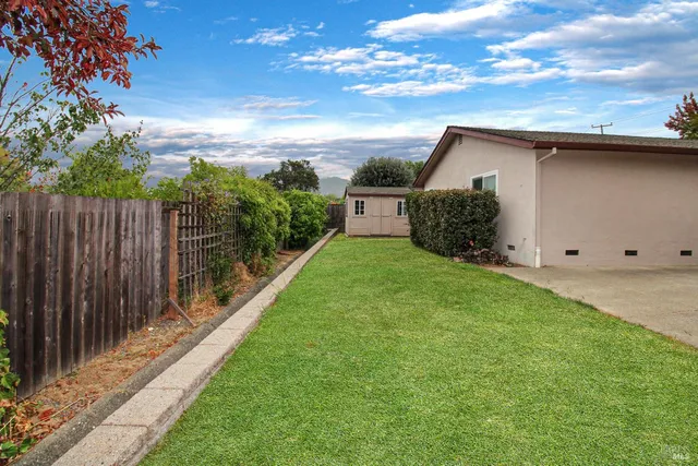 a view of a house with backyard and porch