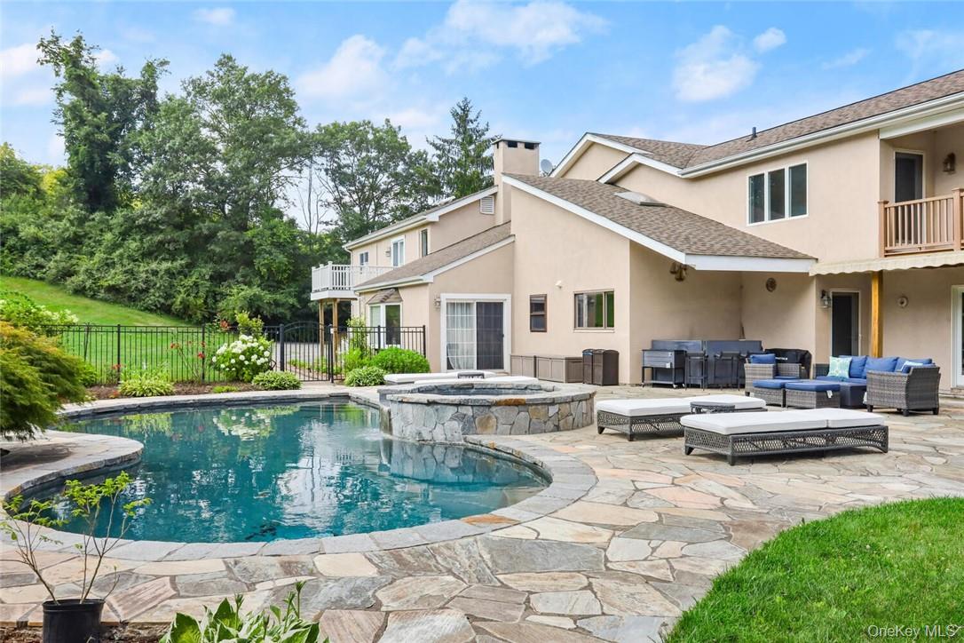 a view of a house with swimming pool and sitting area
