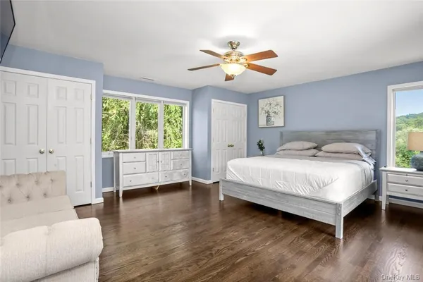 a bedroom with a bed a couch and a window