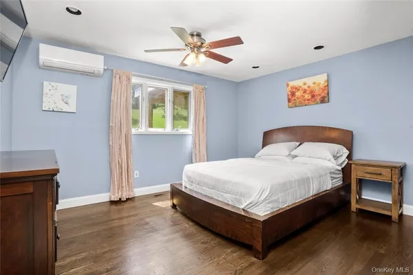 a bedroom with a bed and window