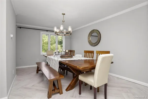 a view of a dining room with furniture and chandelier
