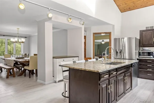 a kitchen with kitchen island a sink stove and refrigerator