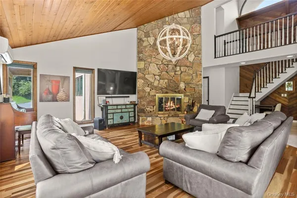 a living room with fireplace furniture and a flat screen tv