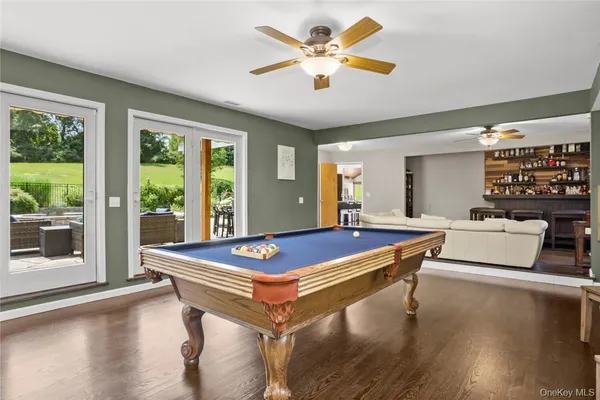 a room with pool table and windows