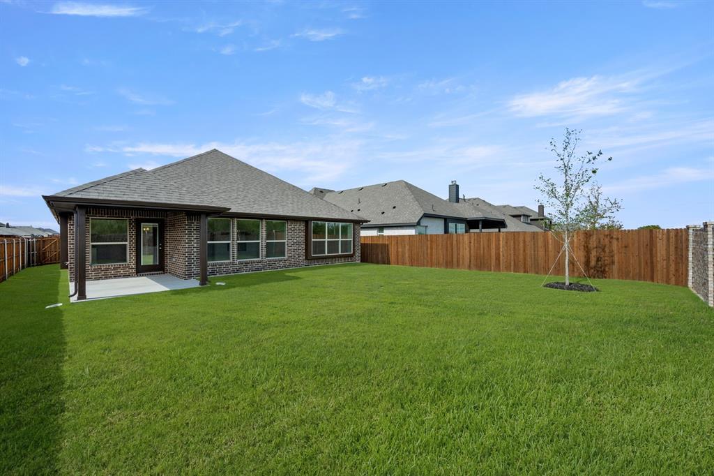 10809 Rothland Street Crowley, TX 76036 - Photo 28 of 30 a front view of a house with a garden