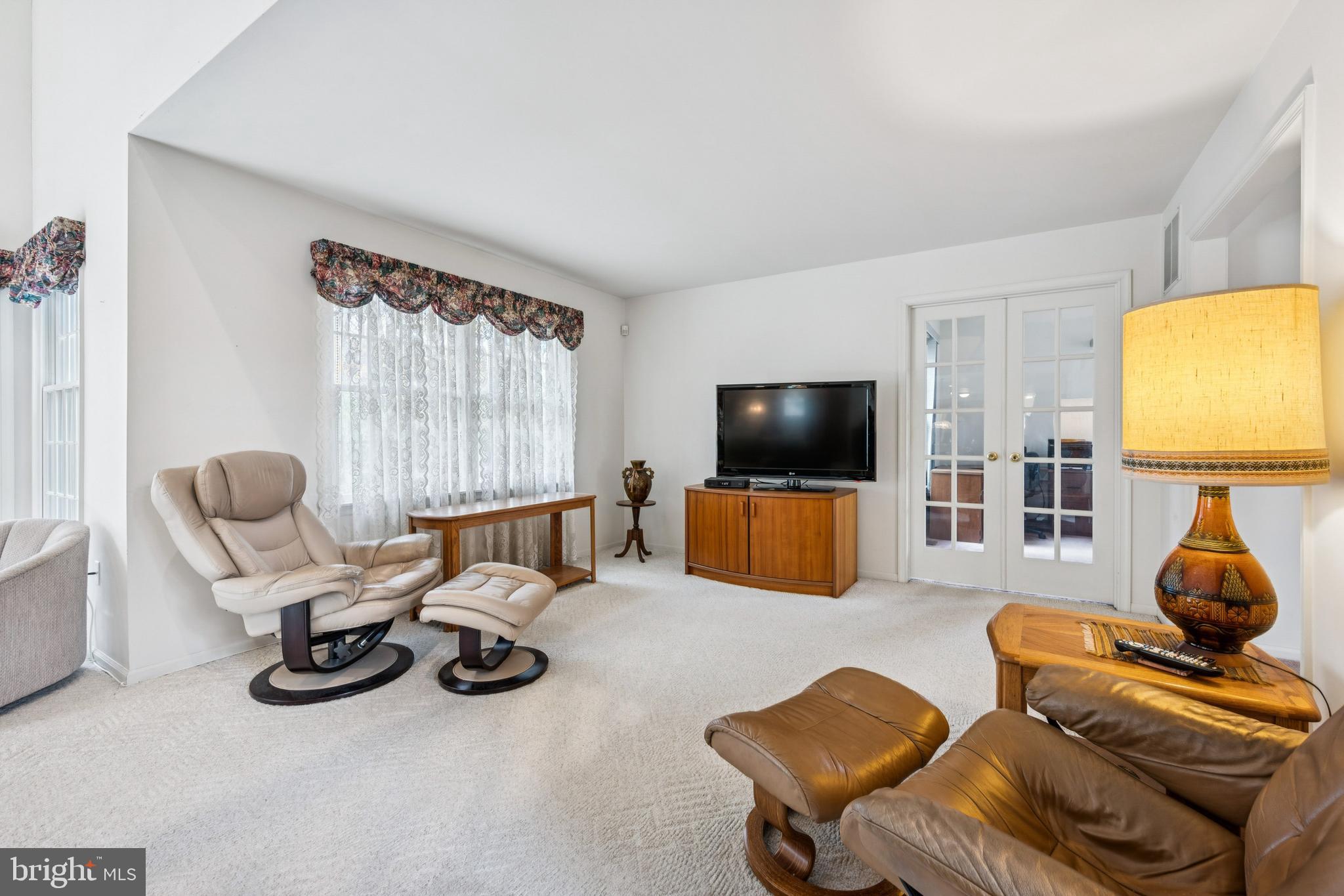 32 Constitution Drive Southampton, NJ 08088 - Photo 17 of 31 a living room with furniture a flat screen tv and a window