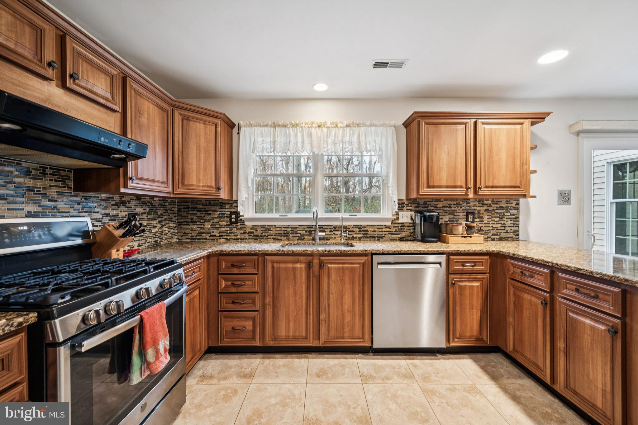 32 Constitution Drive Southampton, NJ 08088 - Photo 10 of 31 a kitchen with stainless steel appliances granite countertop a stove a sink dishwasher and a microwave oven with cabinets