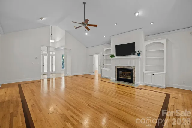 a living room with furniture and a floor to ceiling window