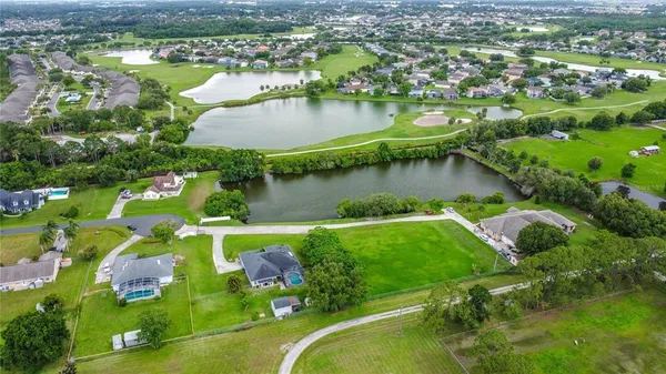 an aerial view of lake residential houses with outdoor space and lake view