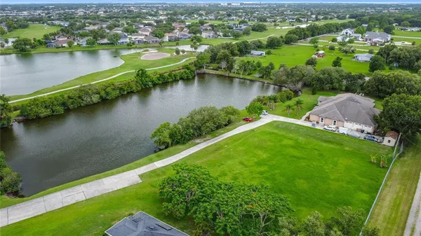 an aerial view of a house with a lake view