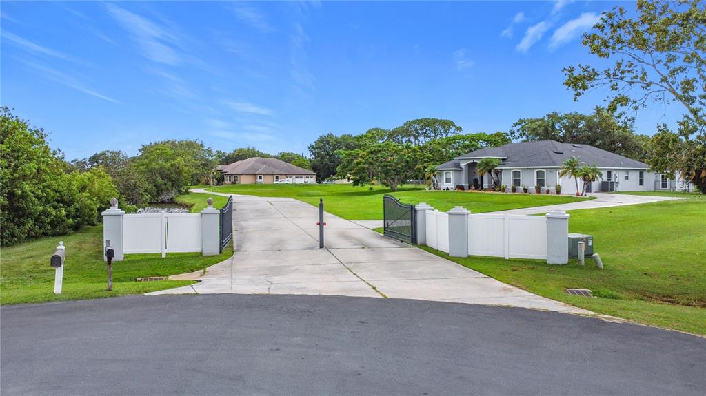 2959 Monica Terrace Kissimmee, FL 34744 - Photo 22 of 23 a view of a house with a yard and a large tree