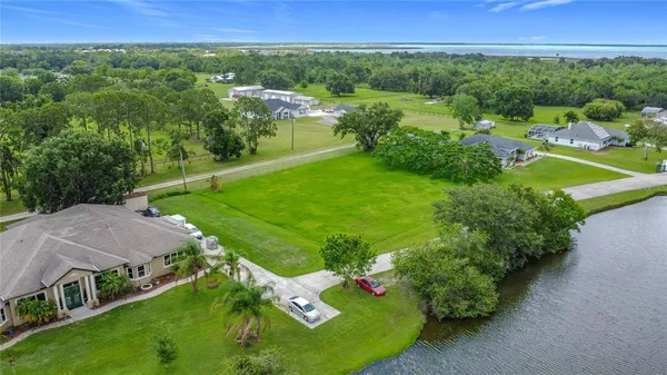 an aerial view of a house with yard