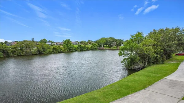 a view of a lake with houses in the back