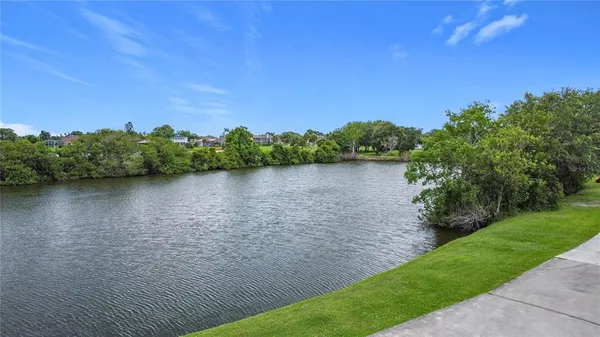 a view of a lake with houses in the back