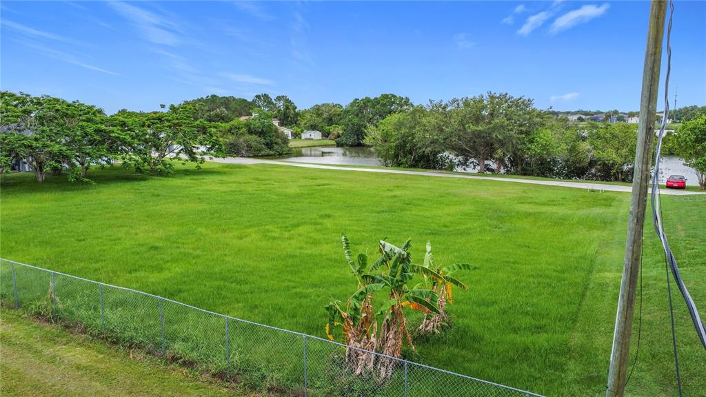 2959 Monica Terrace Kissimmee, FL 34744 - Photo 10 of 23 a view of a field with a tree in a yard