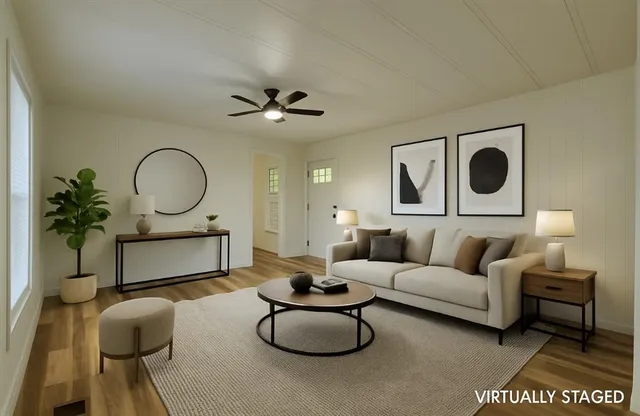 a living room with furniture a rug and a mirror