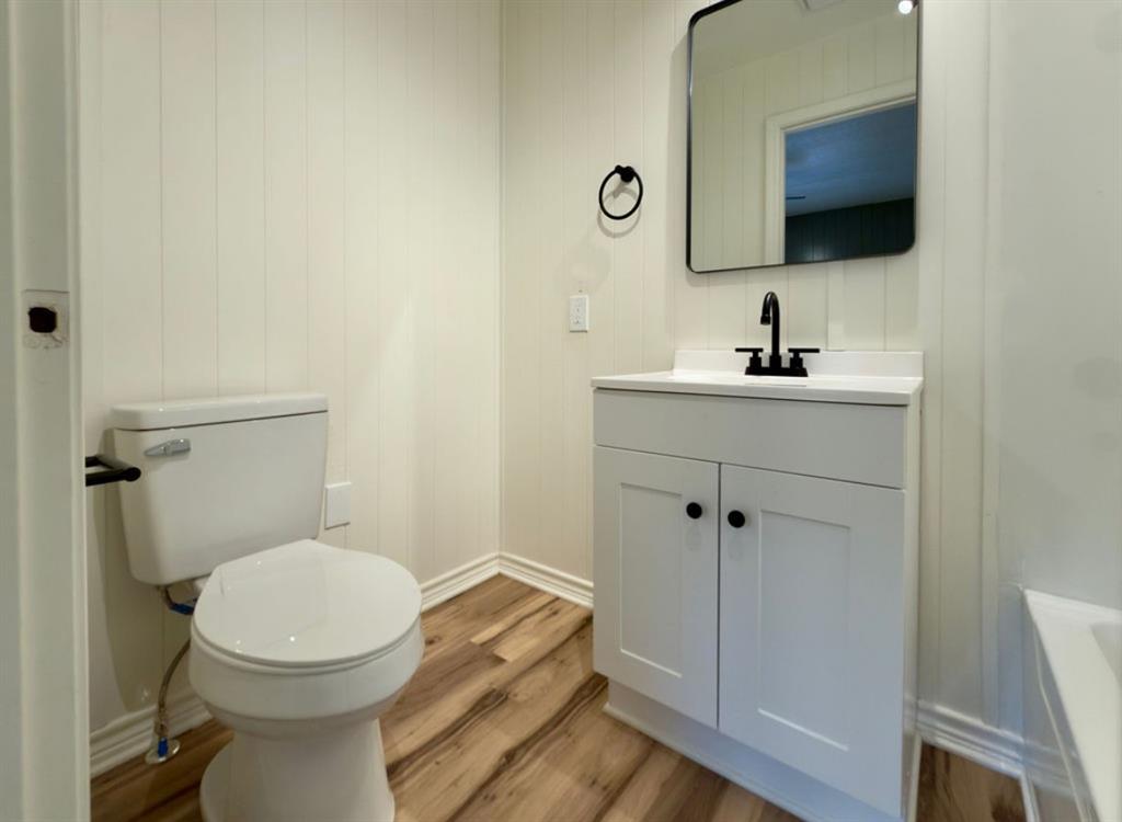 305 West Bryant Street Elm Mott, TX 76640 - Photo 11 of 19 Bathroom featuring light wood-style flooring and vanity