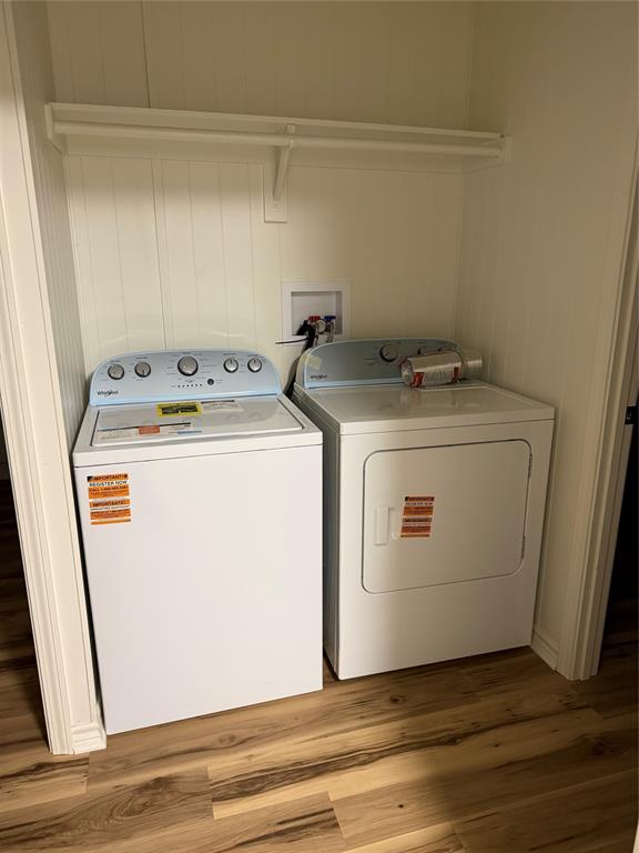 305 West Bryant Street Elm Mott, TX 76640 - Photo 8 of 19 Washroom with wood finished floors and washer and dryer