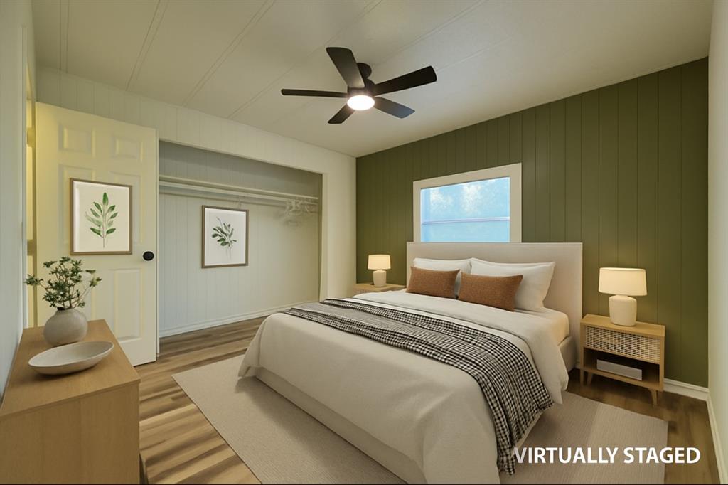 305 West Bryant Street Elm Mott, TX 76640 - Photo 9 of 19 Bedroom featuring wood finished floors, ceiling fan, wooden walls, and a closet