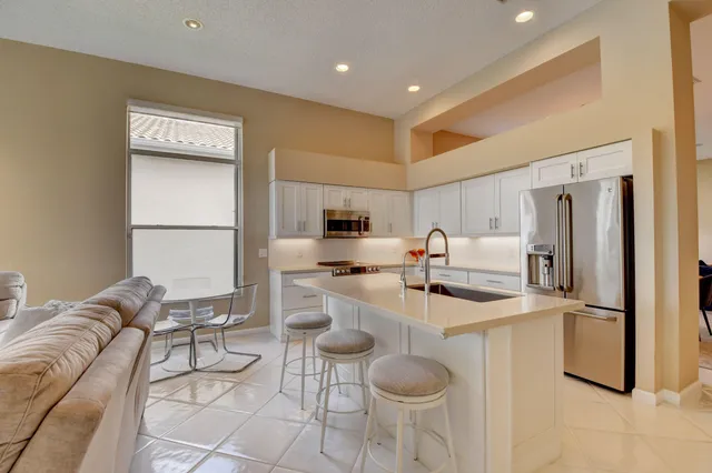 a living room with furniture a large window and a wooden floor