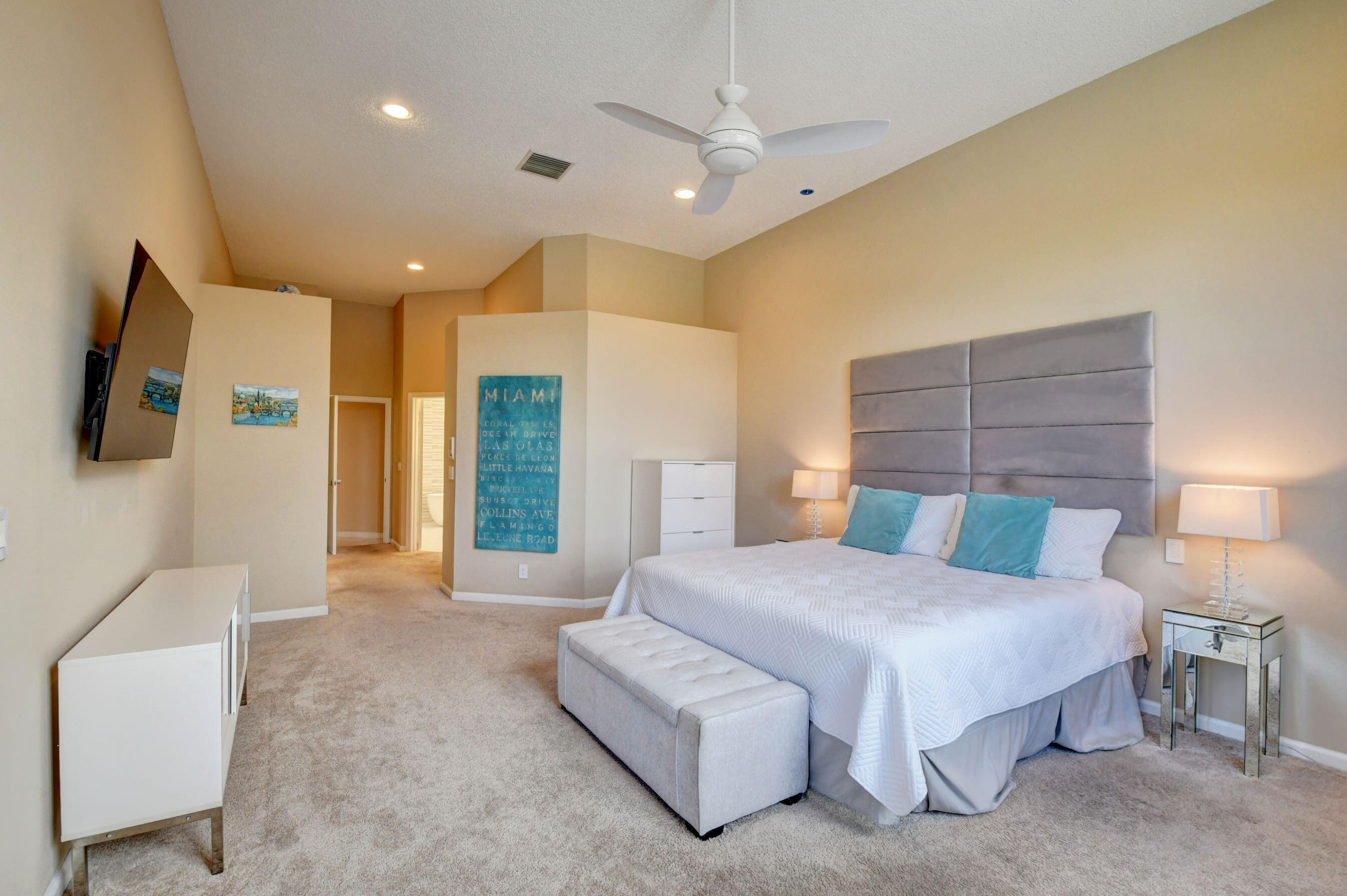 2331 Northwest 66th Drive Boca Raton, FL 33496 - Photo 25 of 71 a bedroom with a large bed couch and a chandelier