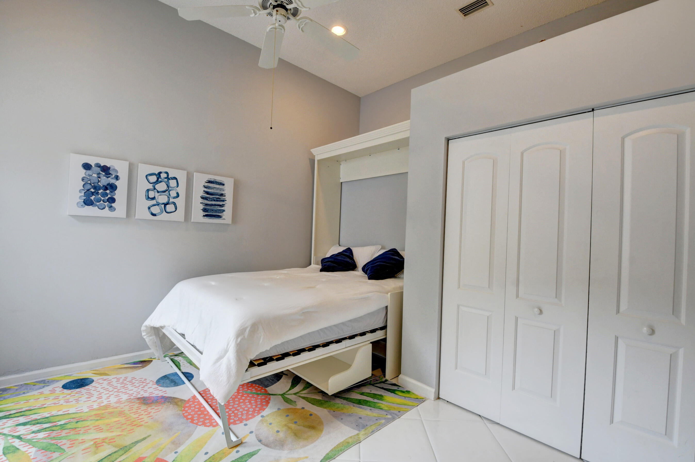 2331 Northwest 66th Drive Boca Raton, FL 33496 - Photo 36 of 71 a bedroom with a bed and a chandelier