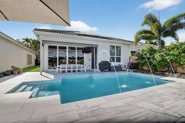 an aerial view of a house with a swimming pool