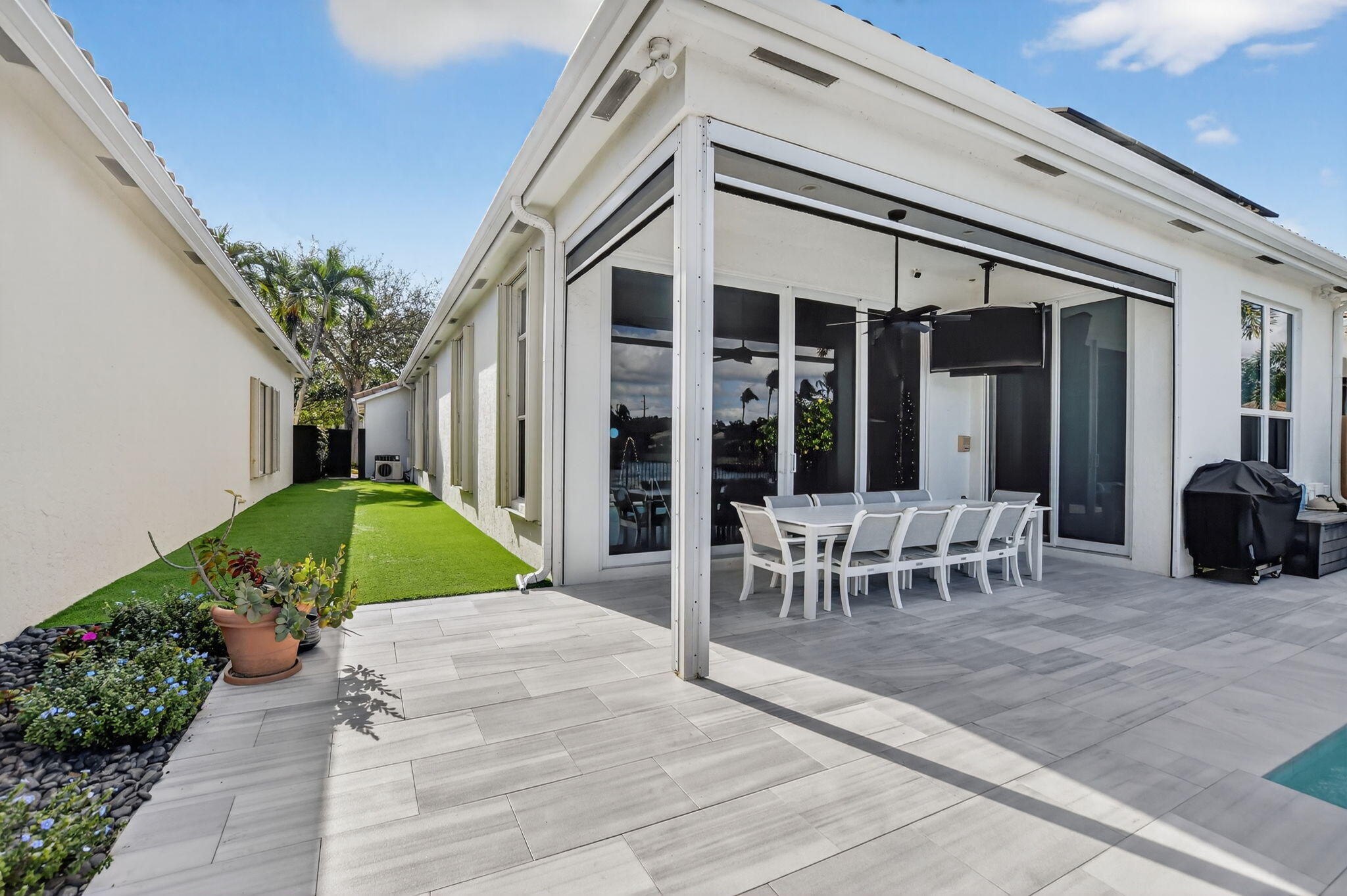 2331 Northwest 66th Drive Boca Raton, FL 33496 - Photo 43 of 71 a view of a patio with table and chairs and potted plants