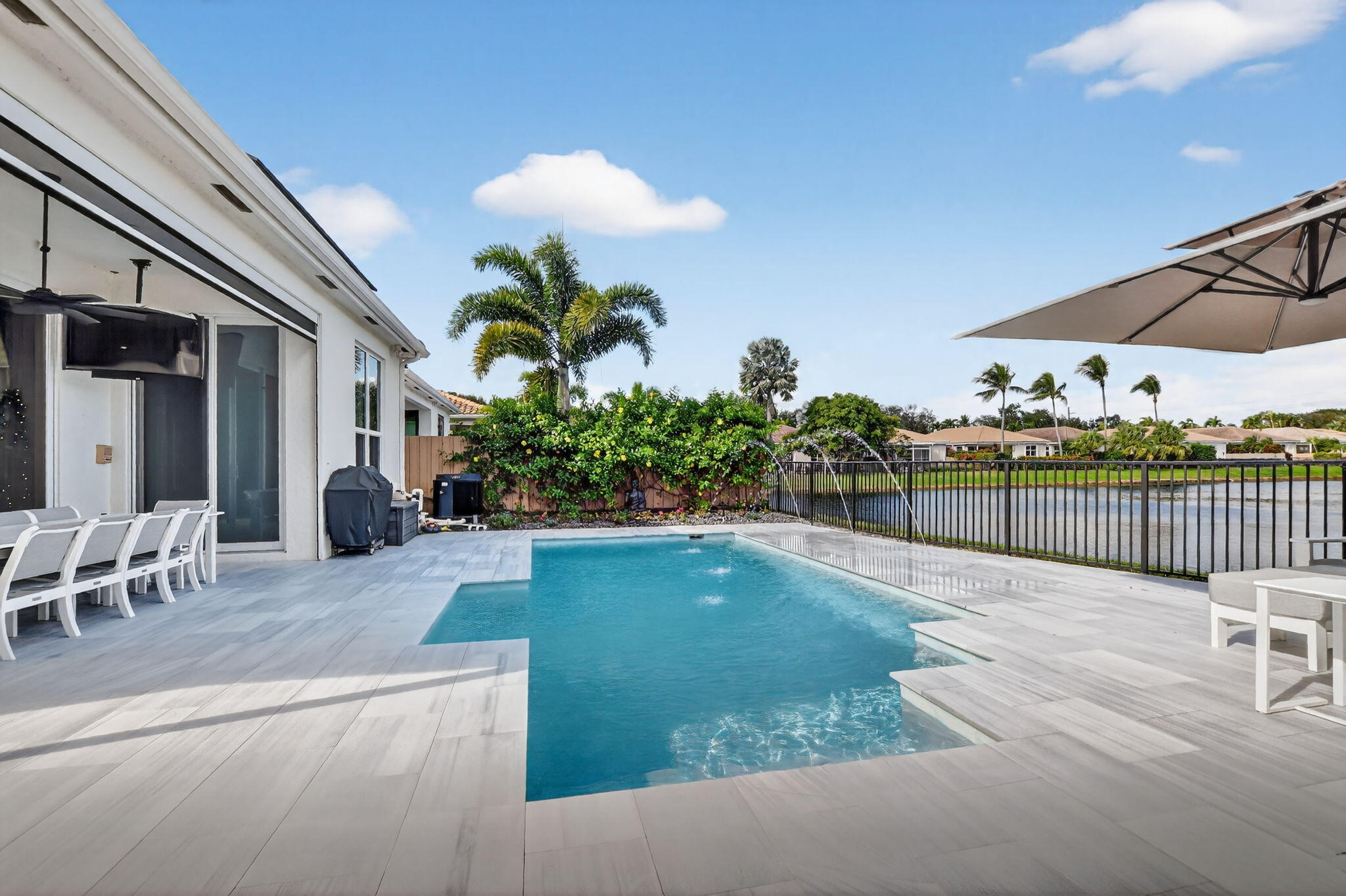 2331 Northwest 66th Drive Boca Raton, FL 33496 - Photo 48 of 71 a swimming pool with potted plants and wooden fence