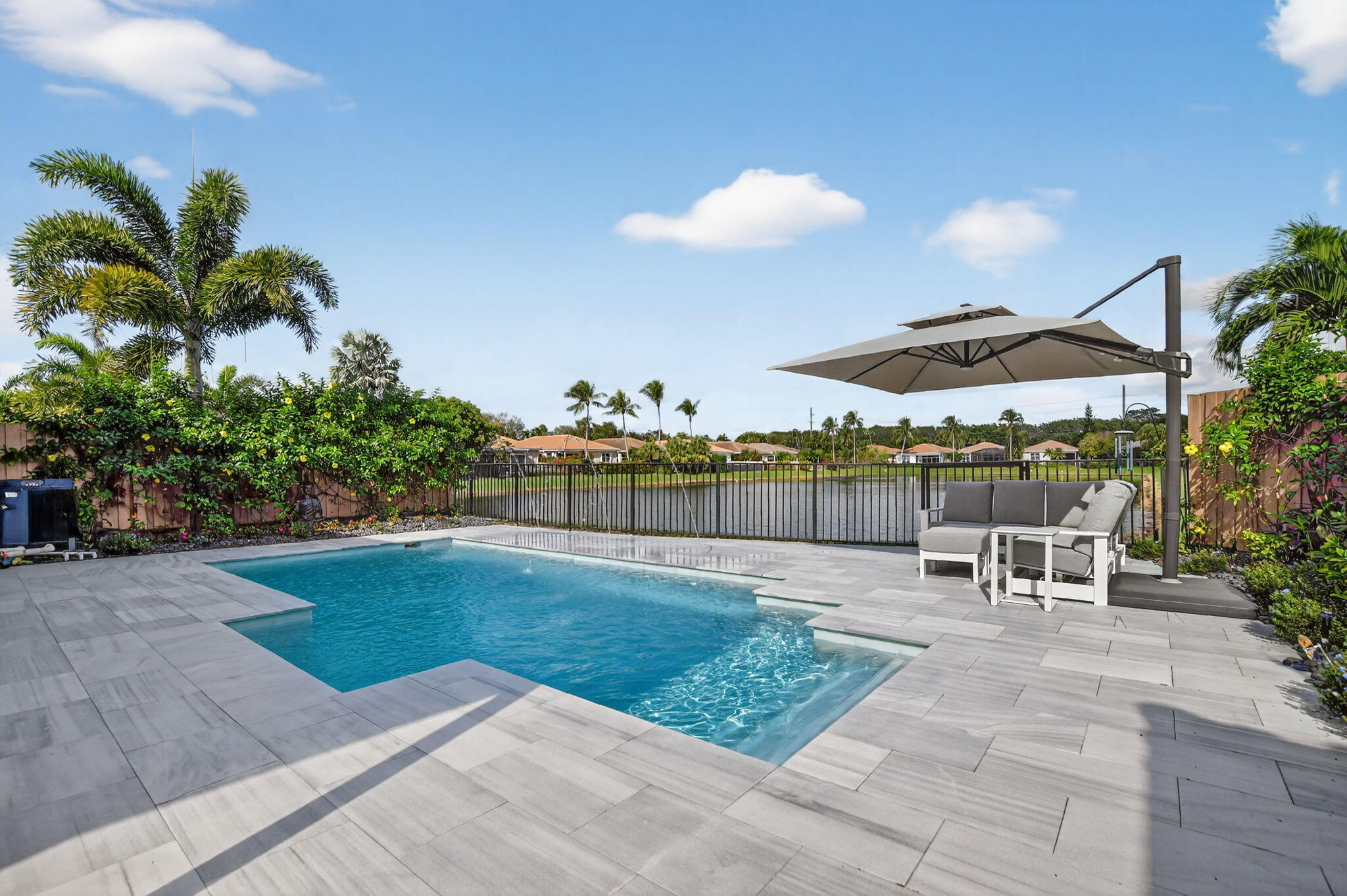 2331 Northwest 66th Drive Boca Raton, FL 33496 - Photo 49 of 71 a view of a backyard with a patio and plants