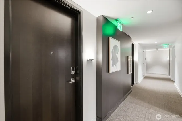 a very nice looking dining room with a large window and stainless steel appliances